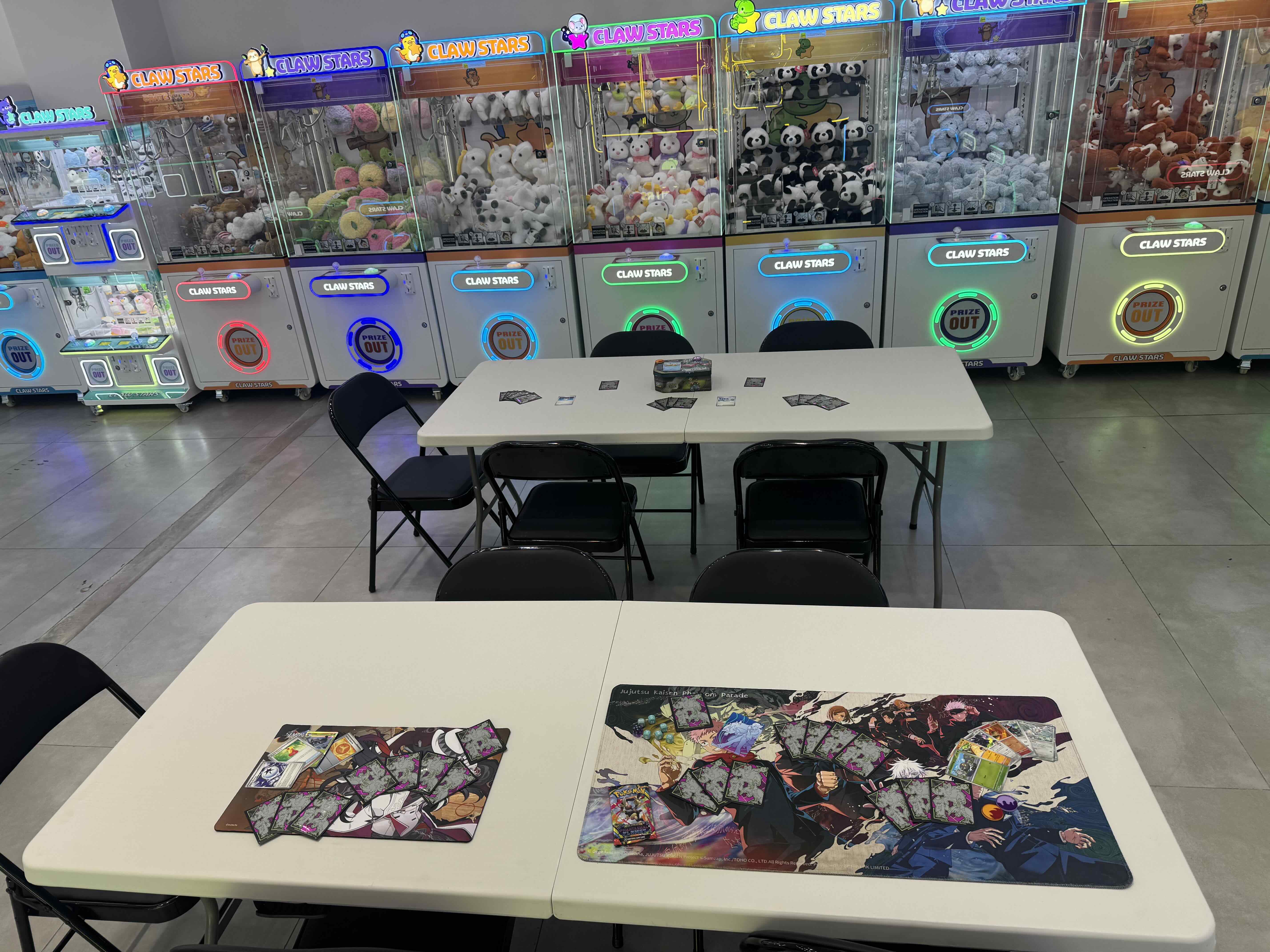 Play tables set up for trading card games at Claw Stars